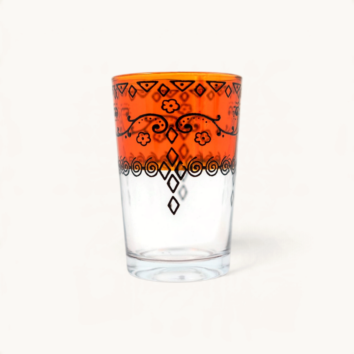 TUYYA Sonor 6oz Moroccan tea glass featuring a vibrant orange rim with intricate black hand-painted floral patterns.