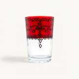 TUYYA 6oz Moroccan tea glass in clear glass with a vibrant red rim and intricate black floral and geometric patterns.