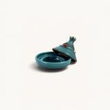 TUYYA handcrafted teal ceramic mini tajine with decorative silver metal ornaments and a conical lid.