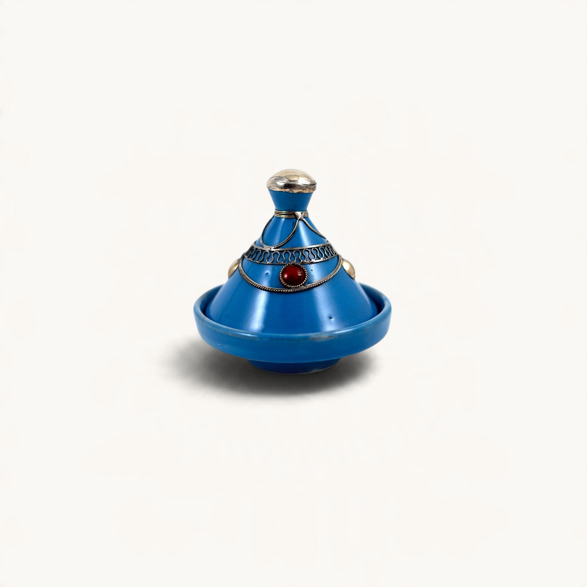 TUYYA blue handcrafted ceramic mini tajine with silver metal ornaments and a red stone accent on a white background.
