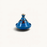 TUYYA blue handcrafted ceramic mini tajine with silver metal ornaments and a red stone accent on a white background.