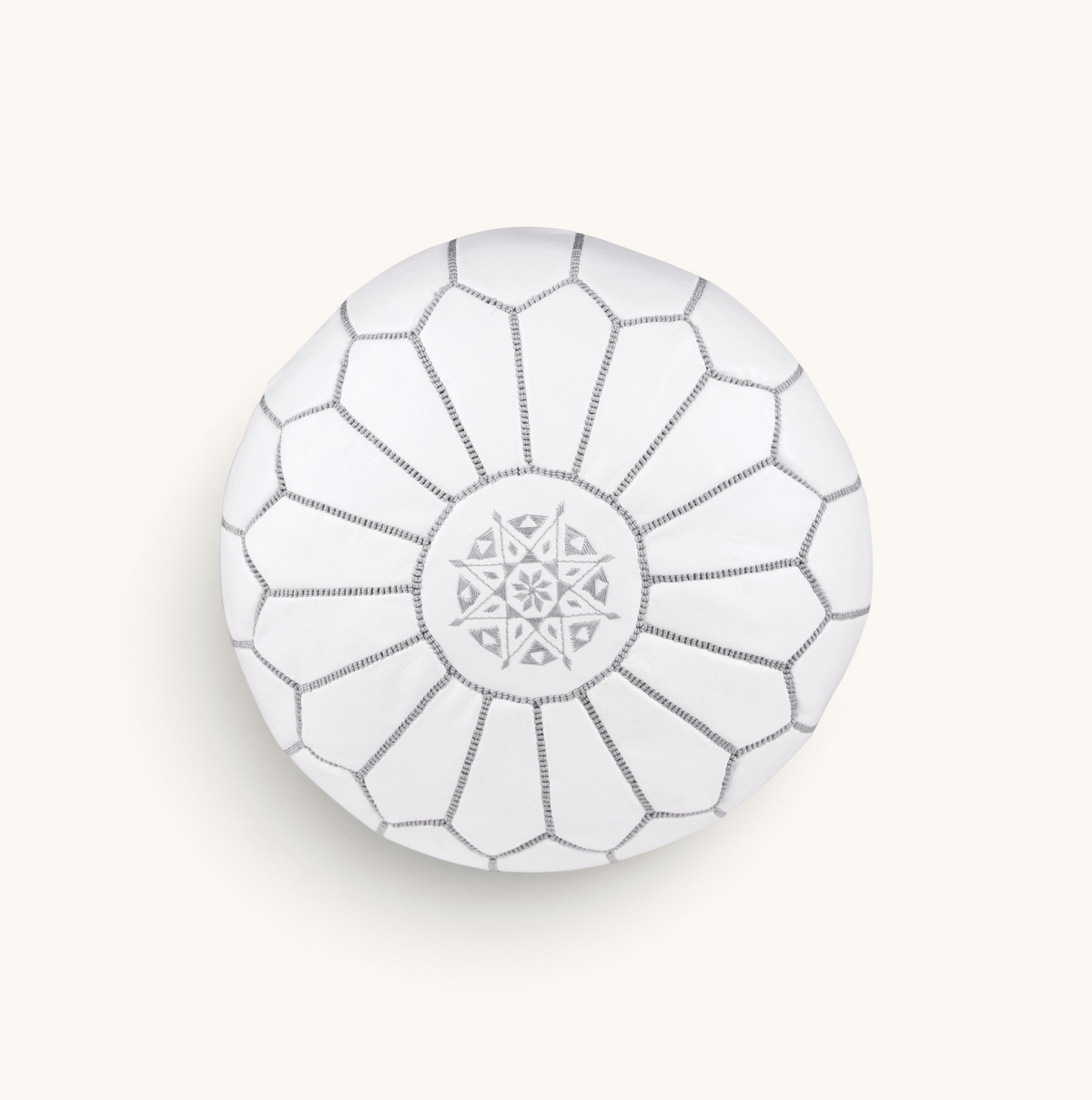 Top view of a white tuyya Moroccan leather pouf featuring intricate hand-stitched embroidery and geometric patterns.