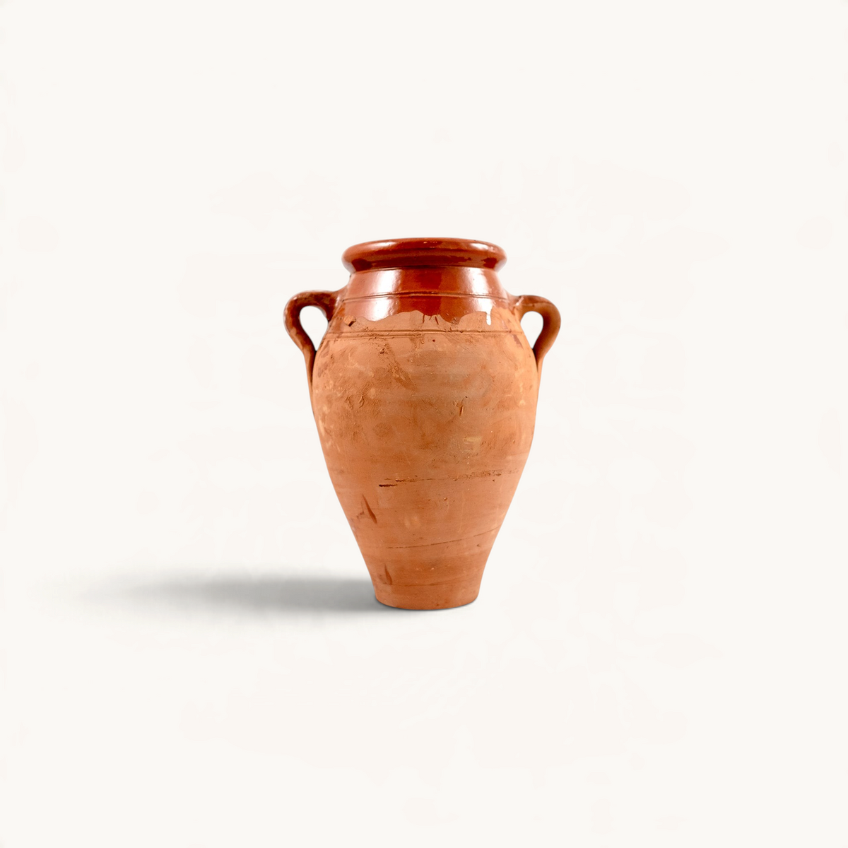 TUYYA handcrafted Moroccan clay Tanjia cookpot with a rustic amphora shape and glazed finish on a white background.