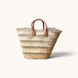 TUYYA handwoven Moroccan palm leaf basket with brown camel leather handles and horizontal etched line details.