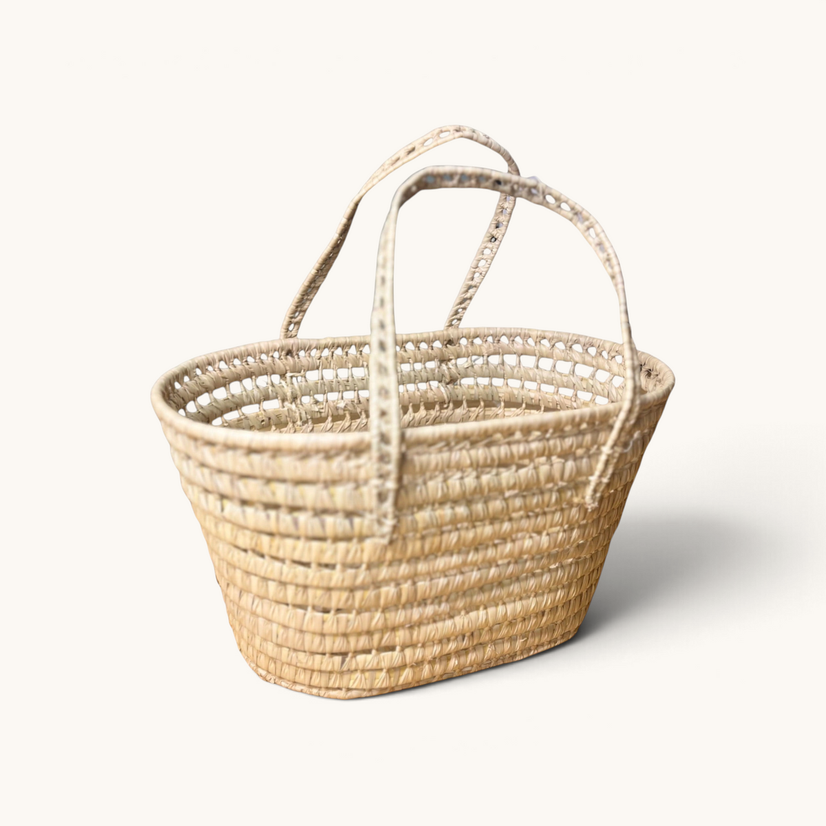 TUYYA Leila minimalist Moroccan wicker basket handcrafted from natural palm leaves with long woven handles