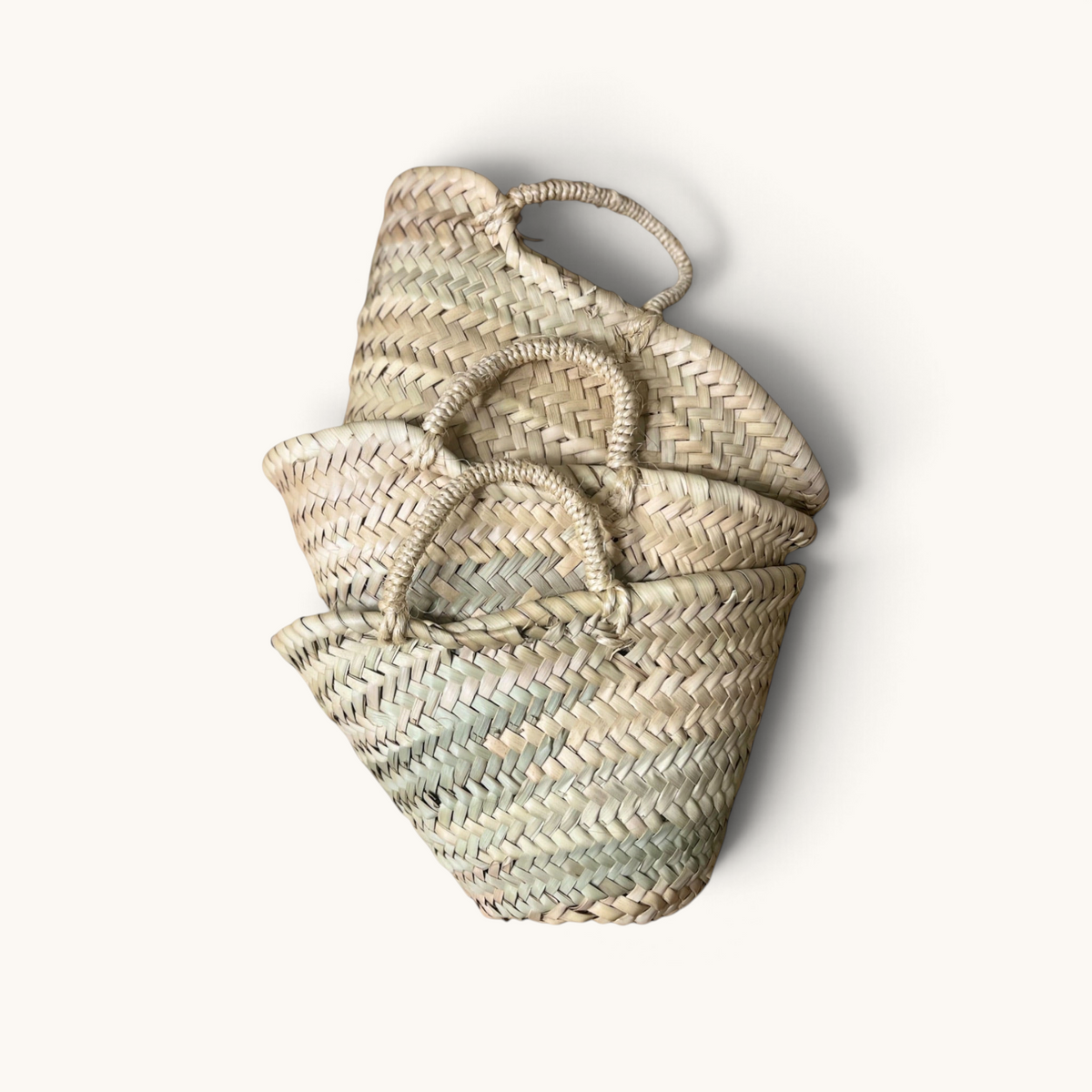 TUYYA Lilou small handwoven Moroccan wicker baskets stacked together, featuring natural fibers and simple handles.