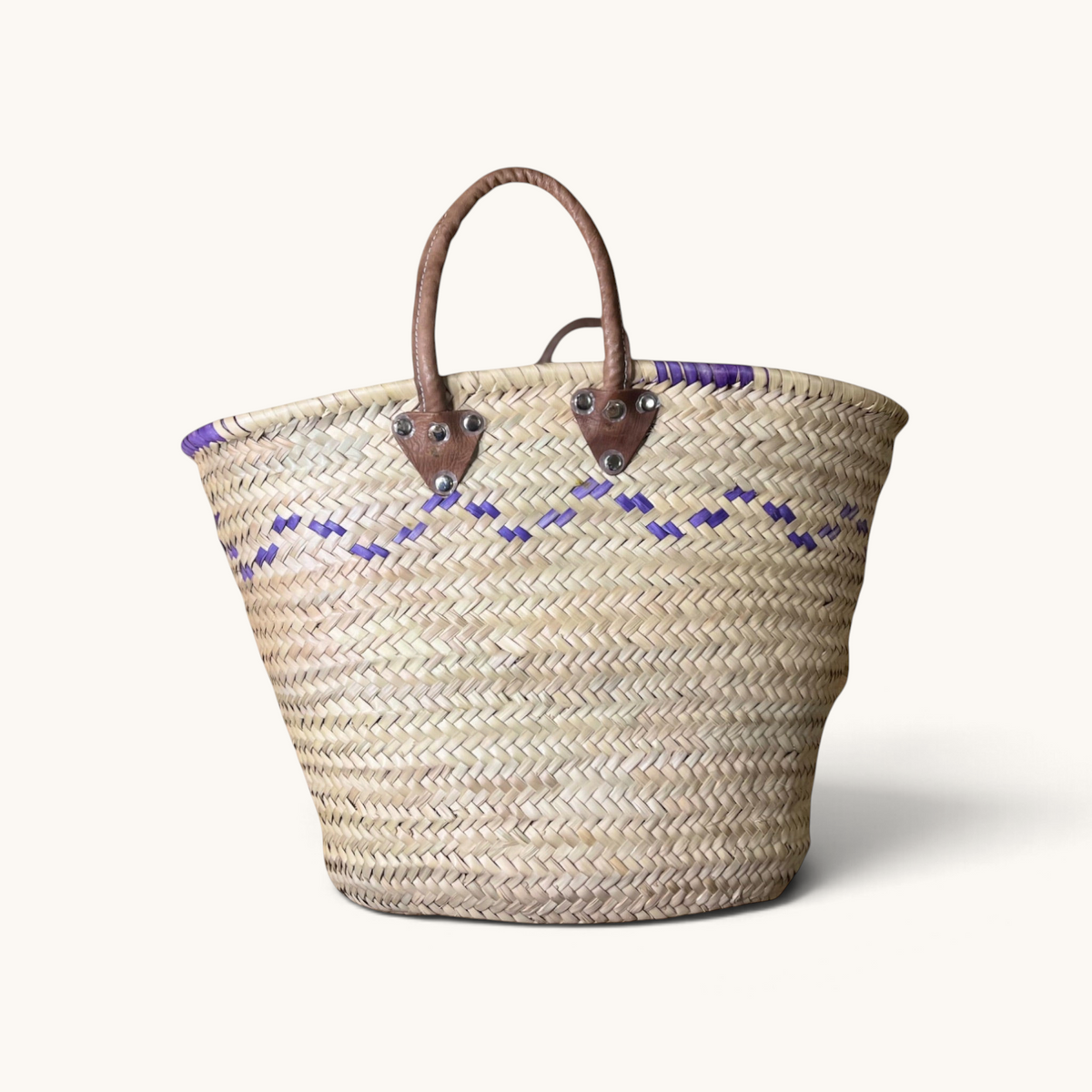 TUYYA Mimmi Moroccan wicker basket with purple wave patterns and sturdy brown leather handles.