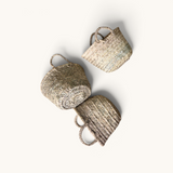 Three tuyya petite handcrafted Moroccan wicker baskets with woven handles arranged on a white background.