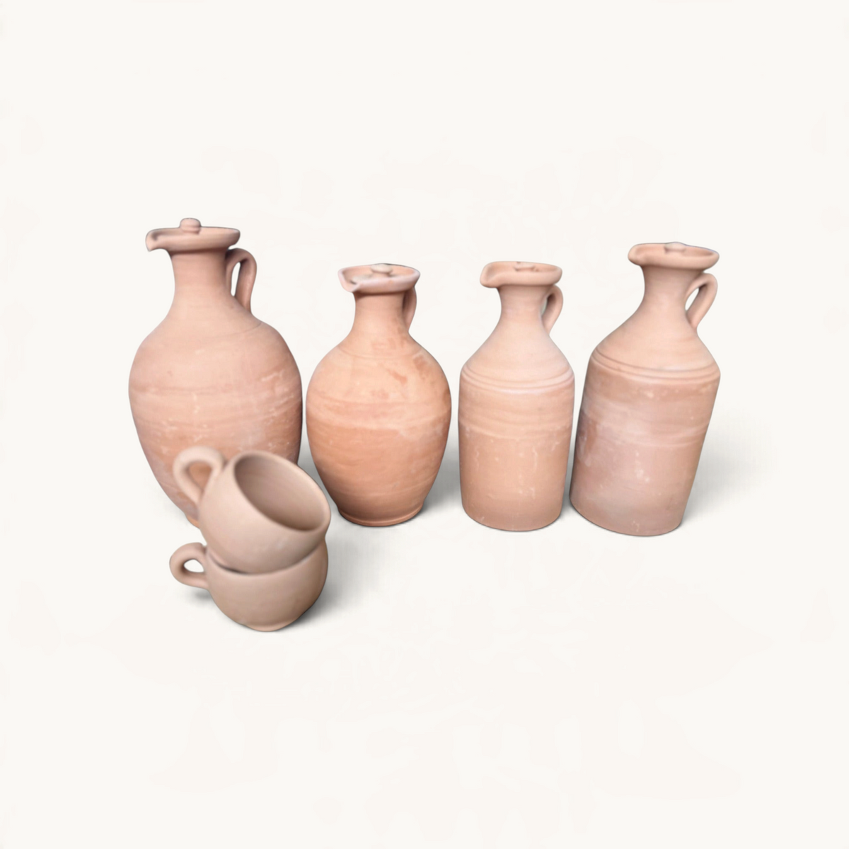 TUYYA handmade Moroccan terracotta water jars and matching clay cups with rounded designs and natural clay finish.
