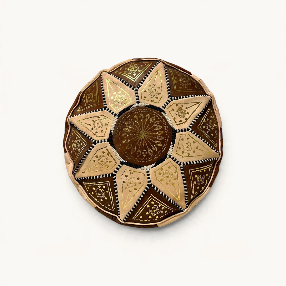 TUYYA hand-stitched goat leather ottoman in brown and sand patchwork with intricate gold floral embroidery.