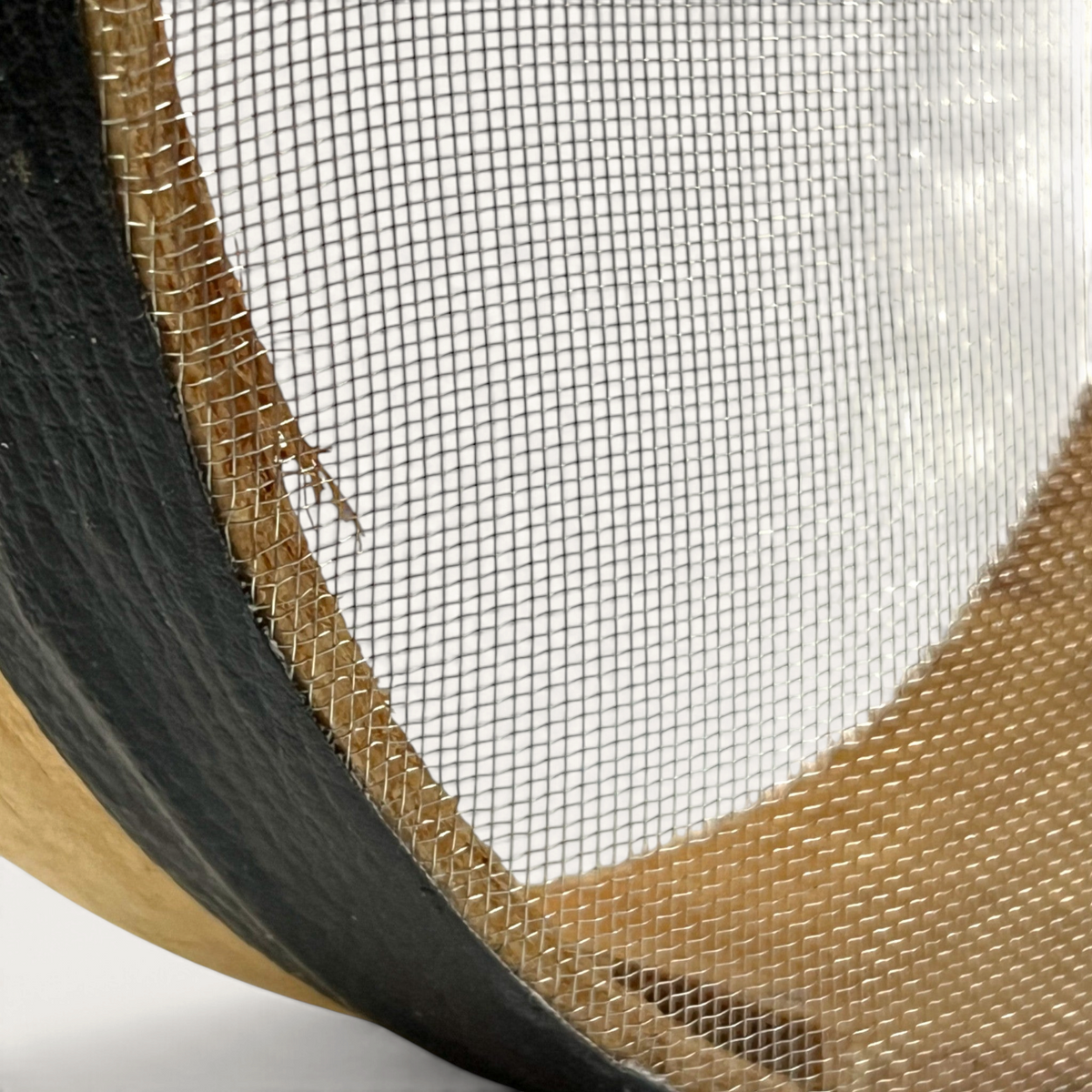Close-up of a TUYYA handcrafted Moroccan wooden sieve showing the fine metal mesh and natural wood frame texture.
