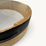 TUYYA handcrafted Moroccan wooden sieve with a fine metal mesh, featuring a natural wood frame and black trim detail.