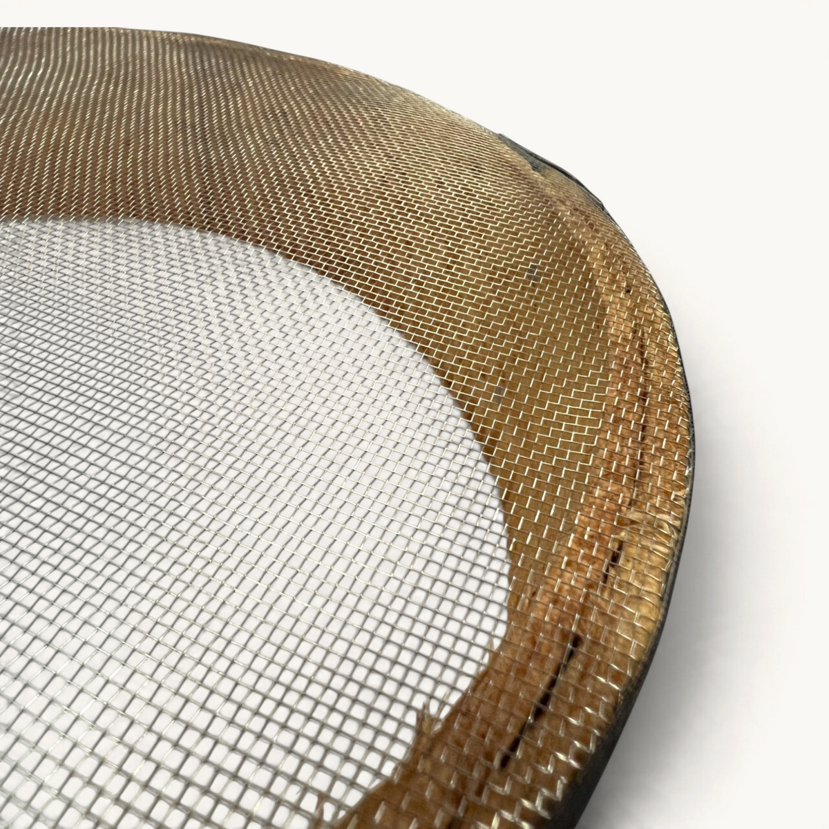 Close-up of a TUYYA handcrafted Moroccan wooden sieve with a fine metal mesh, showing natural wood grain and texture.
