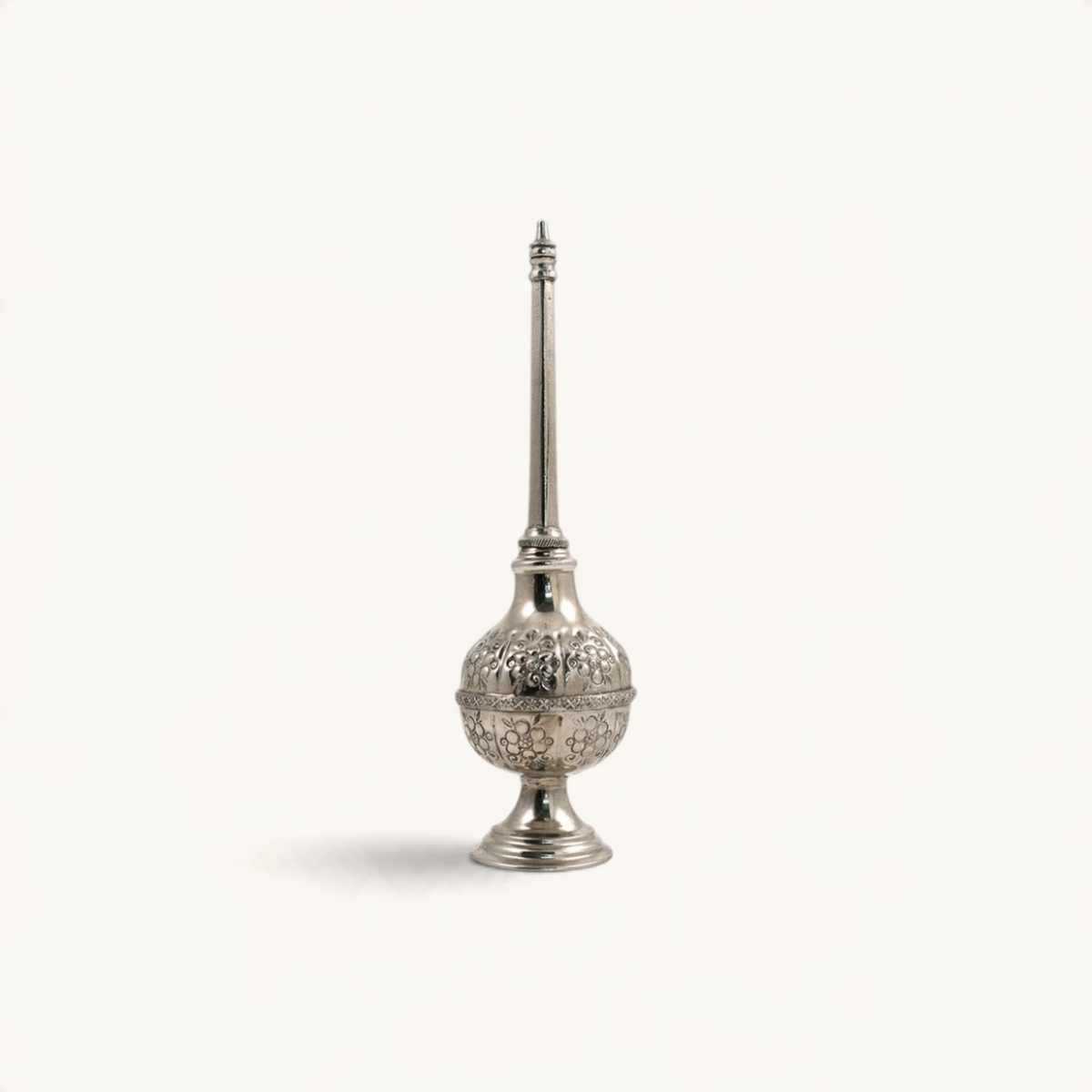 TUYYA handcrafted silver-plated Moroccan rose water sprinkler bottle with intricate hand-embossed floral patterns.