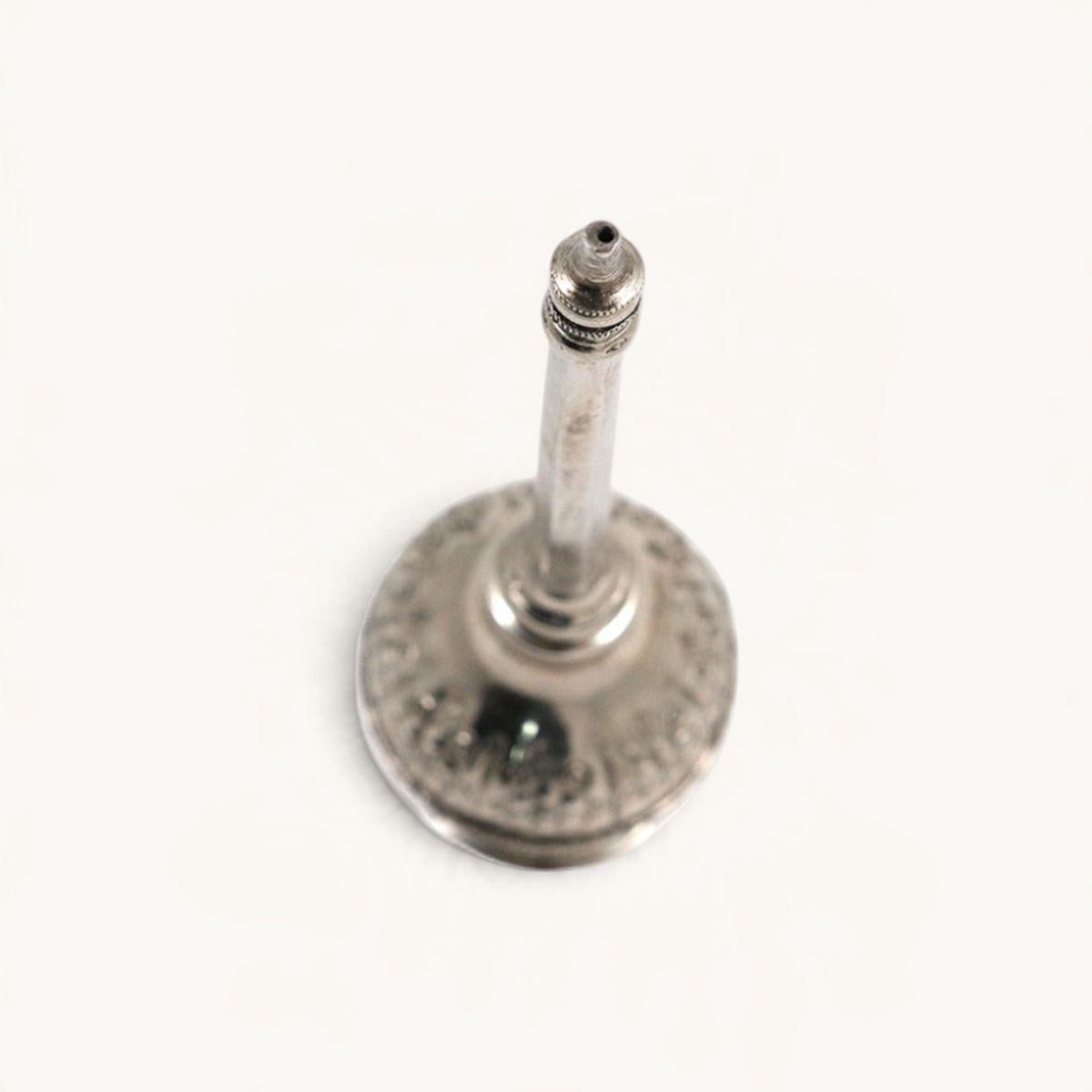 TUYYA silver-plated Moroccan rose water sprinkler bottle with intricate hand-embossed details, top-down view.
