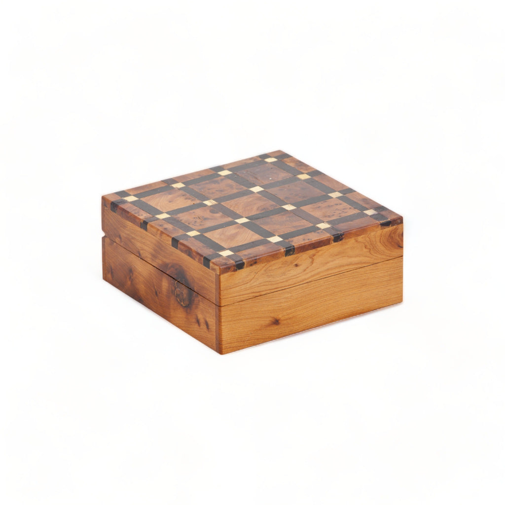 A beautifully handcrafted Thuya Woodbox with lemon wood inlays in an intricate lattice pattern on top, showcasing the artistry of Moroccan craftsmen by TUYYA.