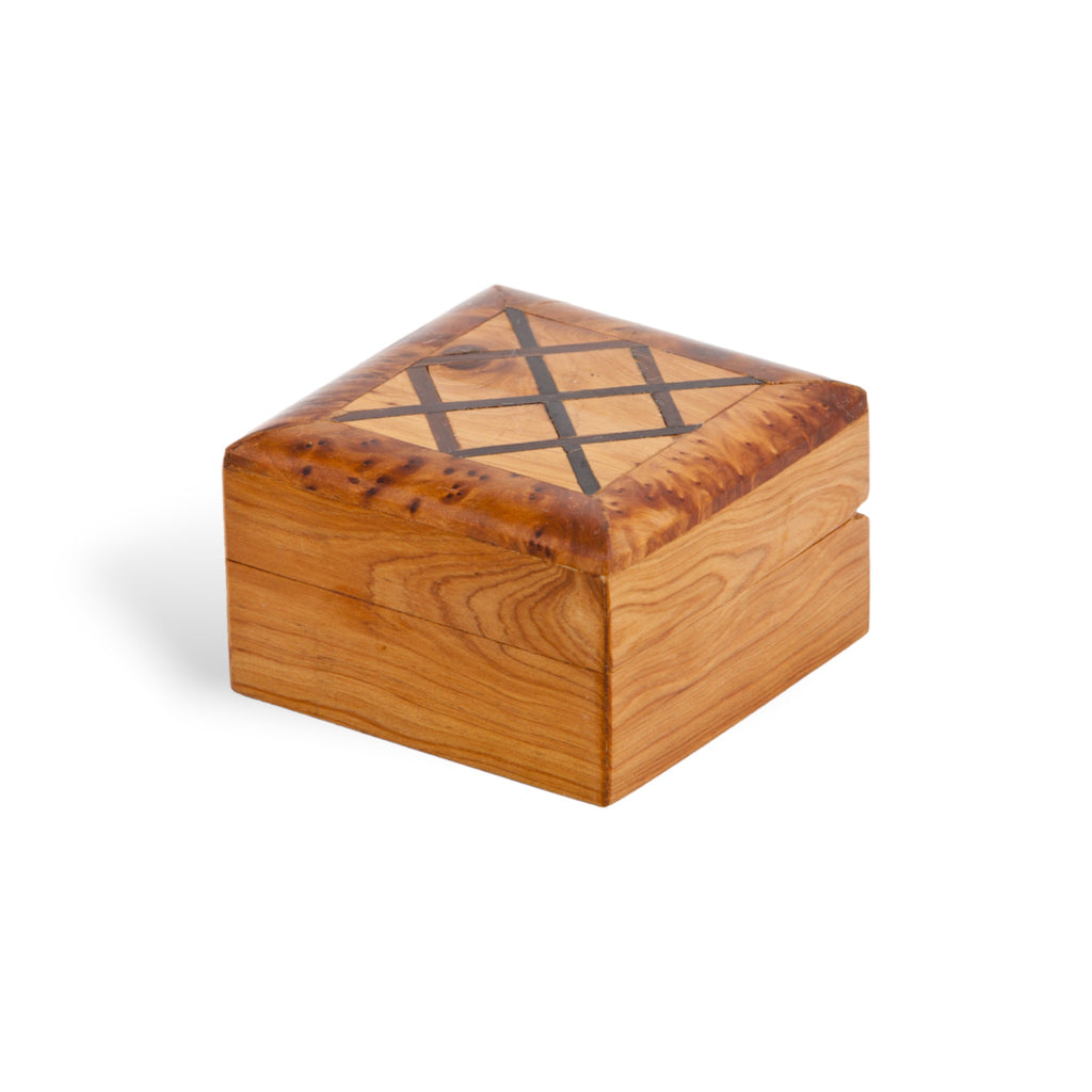 An elegant Thuya Woodbox with mahogany inlays, showcasing a unique shape and expressive thuya burl, handcrafted by Moroccan artisans, presented by TUYYA.