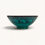 TUYYA handmade green ceramic bowl from Safi, Morocco, featuring a traditional black hand-painted geometric pattern.