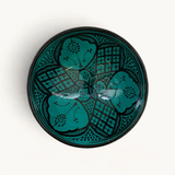 TUYYA handmade Moroccan ceramic bowl in vivid green with intricate black traditional patterns, top-down view.