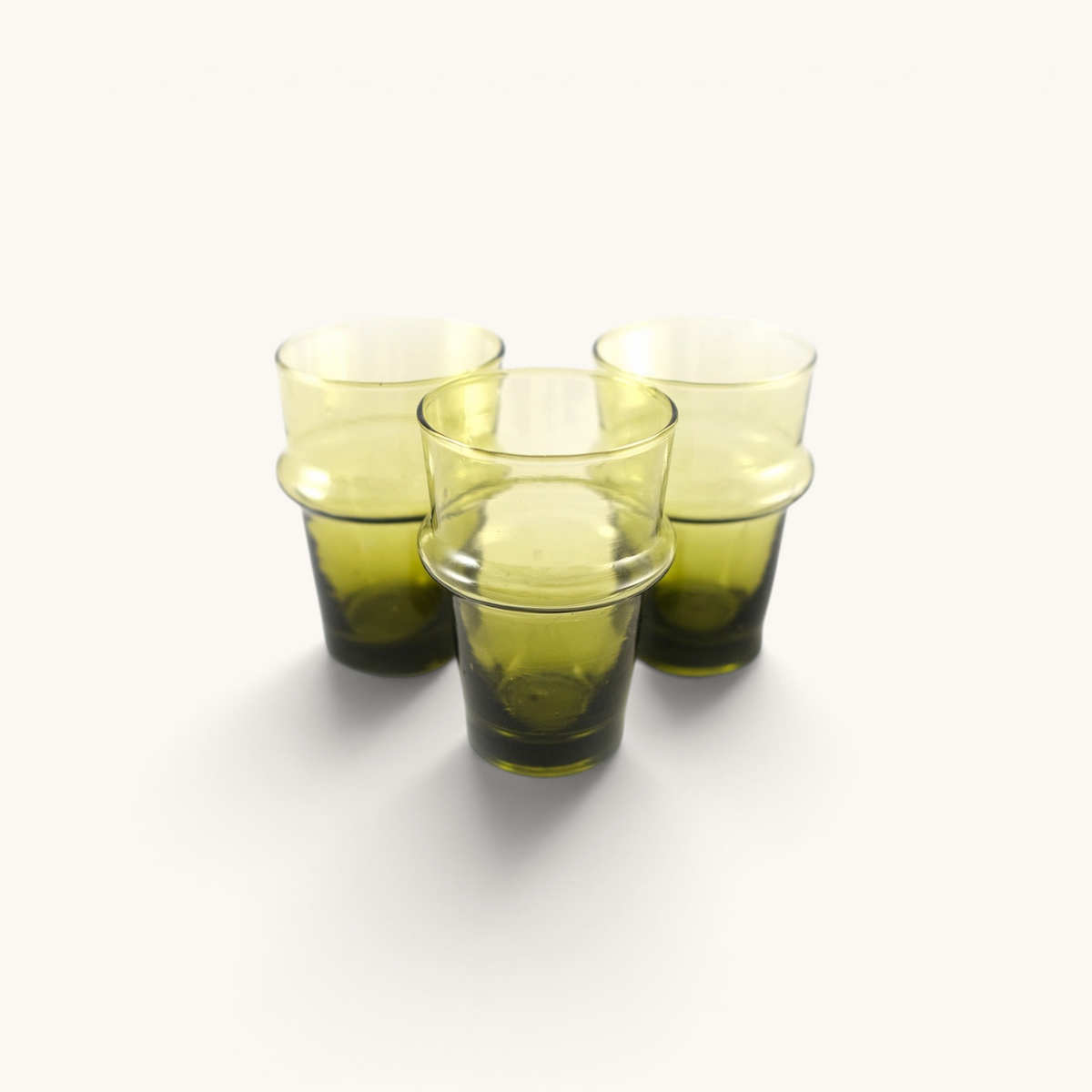 Three tuyya hand-blown green recycled glass Beldi cups with a traditional Moroccan design on a white background.