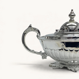 TUYYA Manchester Britishtime silver-plated teapot with ornate handle, lid, and decorative legs on a white background.