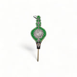 Traditional Moroccan Rabouz with Berber design, used for igniting fires or as a decorative piece, showcasing intricate ciseled patterns and green fabric accents.
