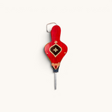 Small Moroccan Rabouz in vibrant red, featuring a traditional Berber shield pattern adorned with copper rivets for an authentic look.