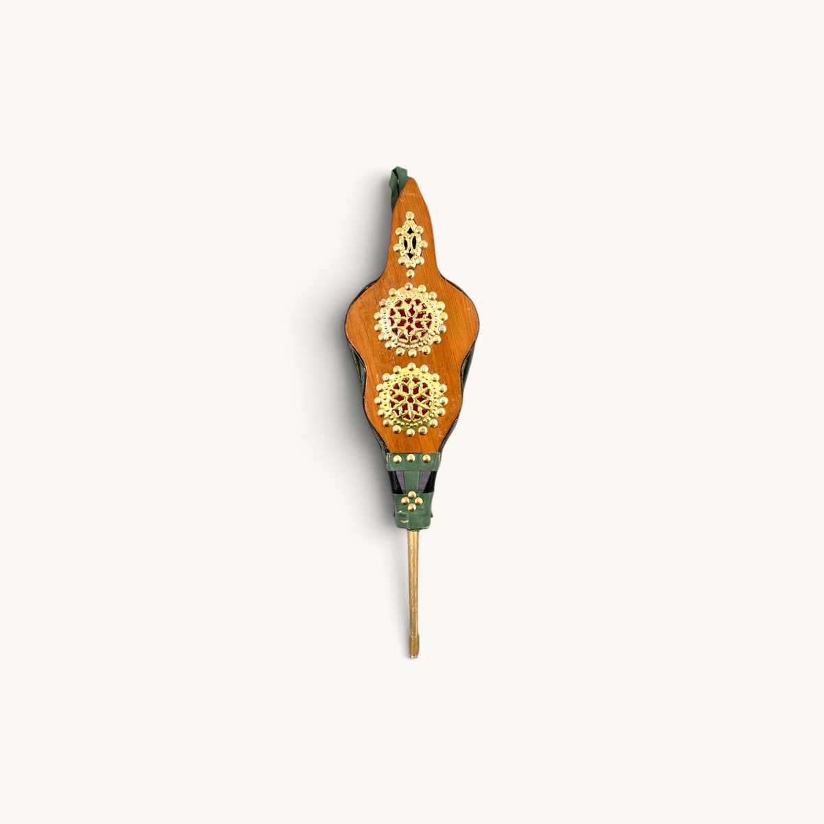 Moroccan Rabouz with green leatherette facade, featuring horizontal copper circles with concentric stars in a Berber pattern. A symbol of artistry and tradition.