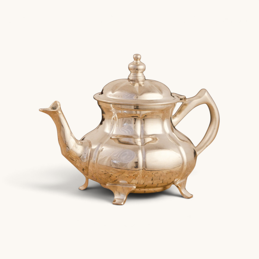 Handcrafted silver-plated tuyya teapot with a classic round shape and ornate legs for traditional Moroccan tea service.