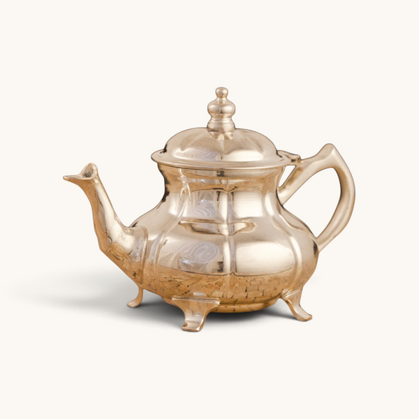 Handcrafted silver-plated tuyya teapot with a classic round shape and ornate legs for traditional Moroccan tea service.