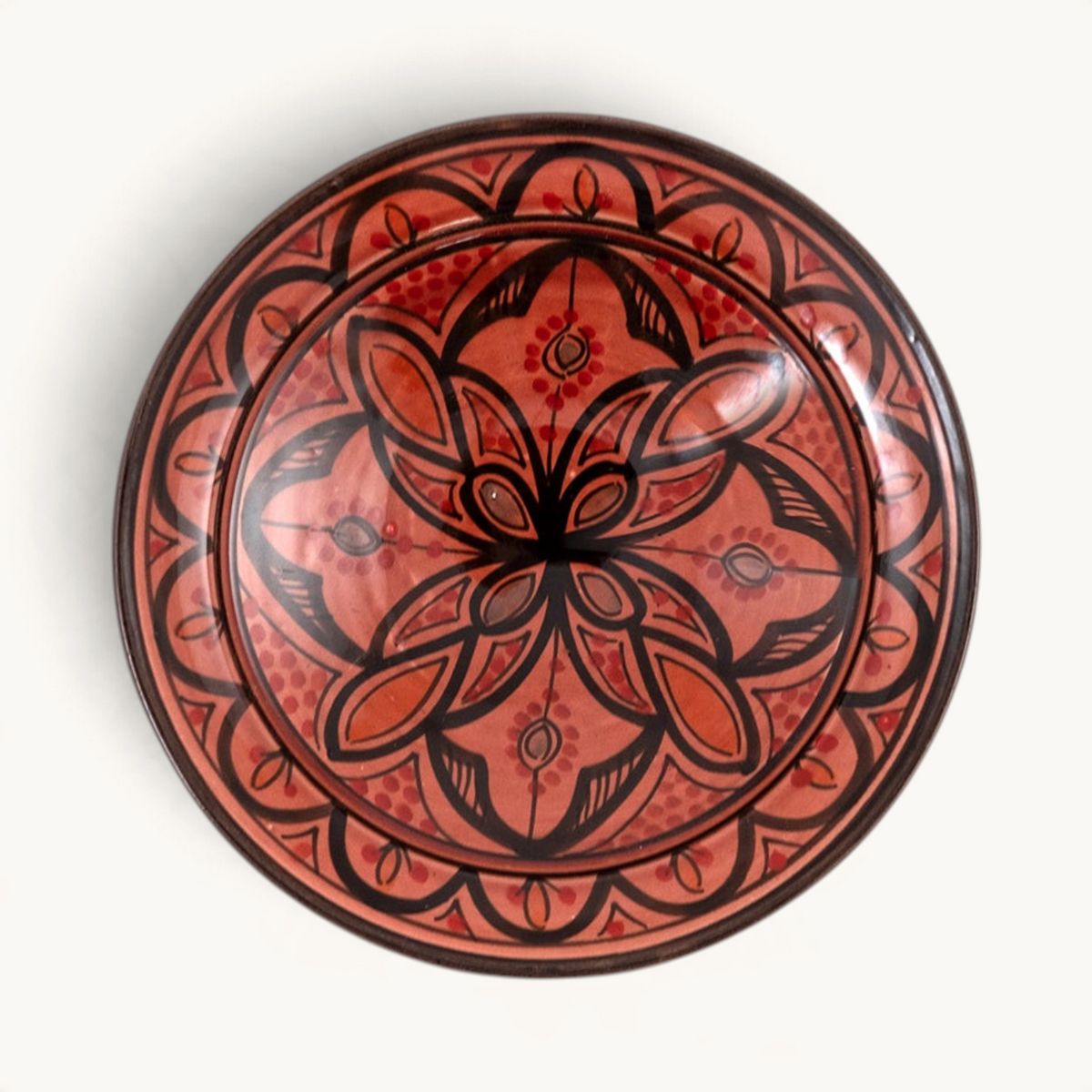 TUYYA handcrafted red clay plate from Asfi featuring intricate black hand-painted Moroccan tribal and floral motifs.