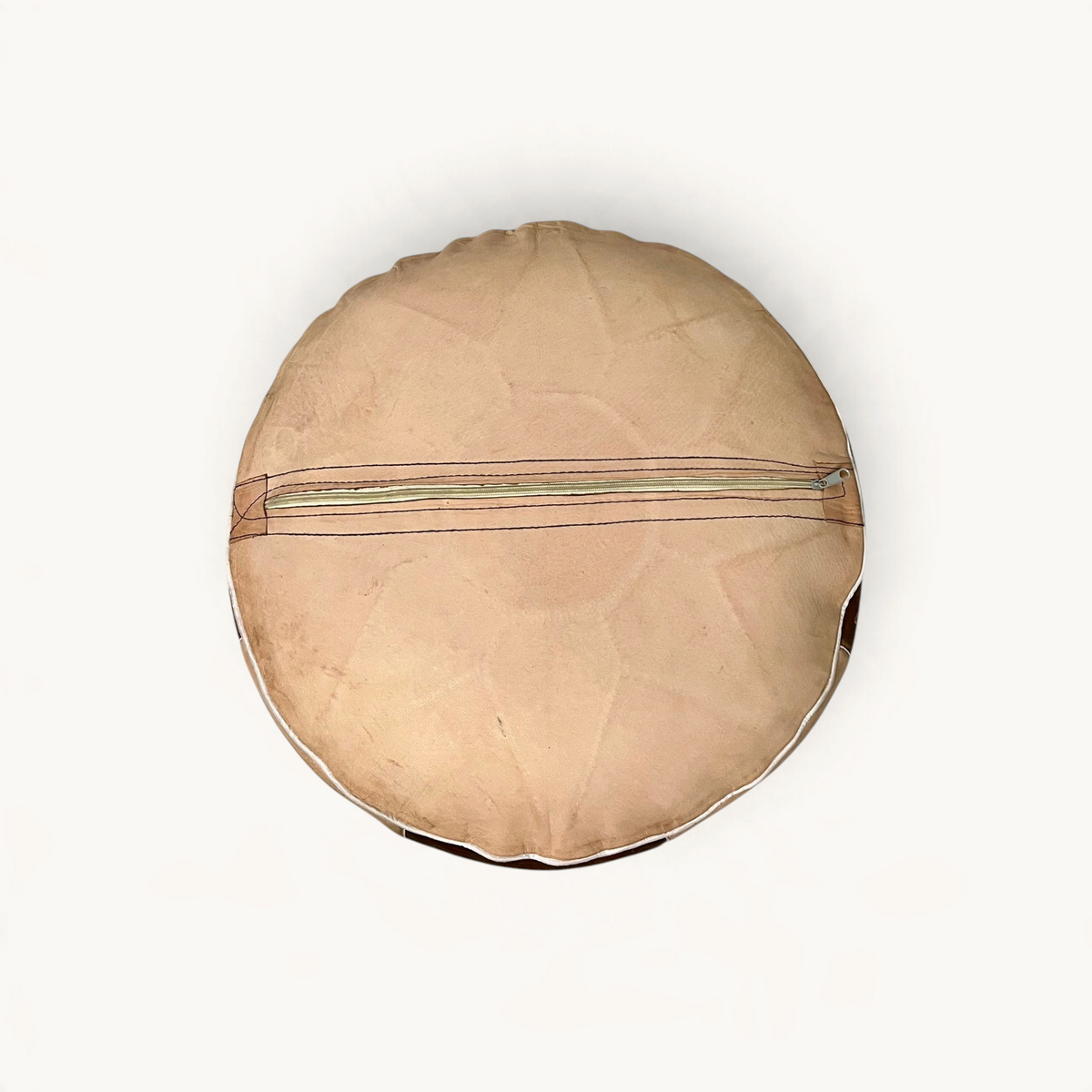 TUYYA round Moroccan goat leather ottoman in brown and sand with a bottom zipper closure