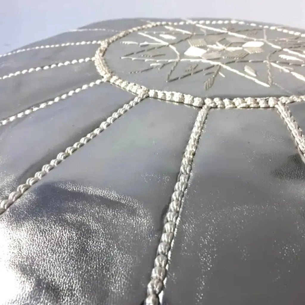 tuyya silver Moroccan vegan leather pouf with intricate hand-embroidered detailing on the top surface