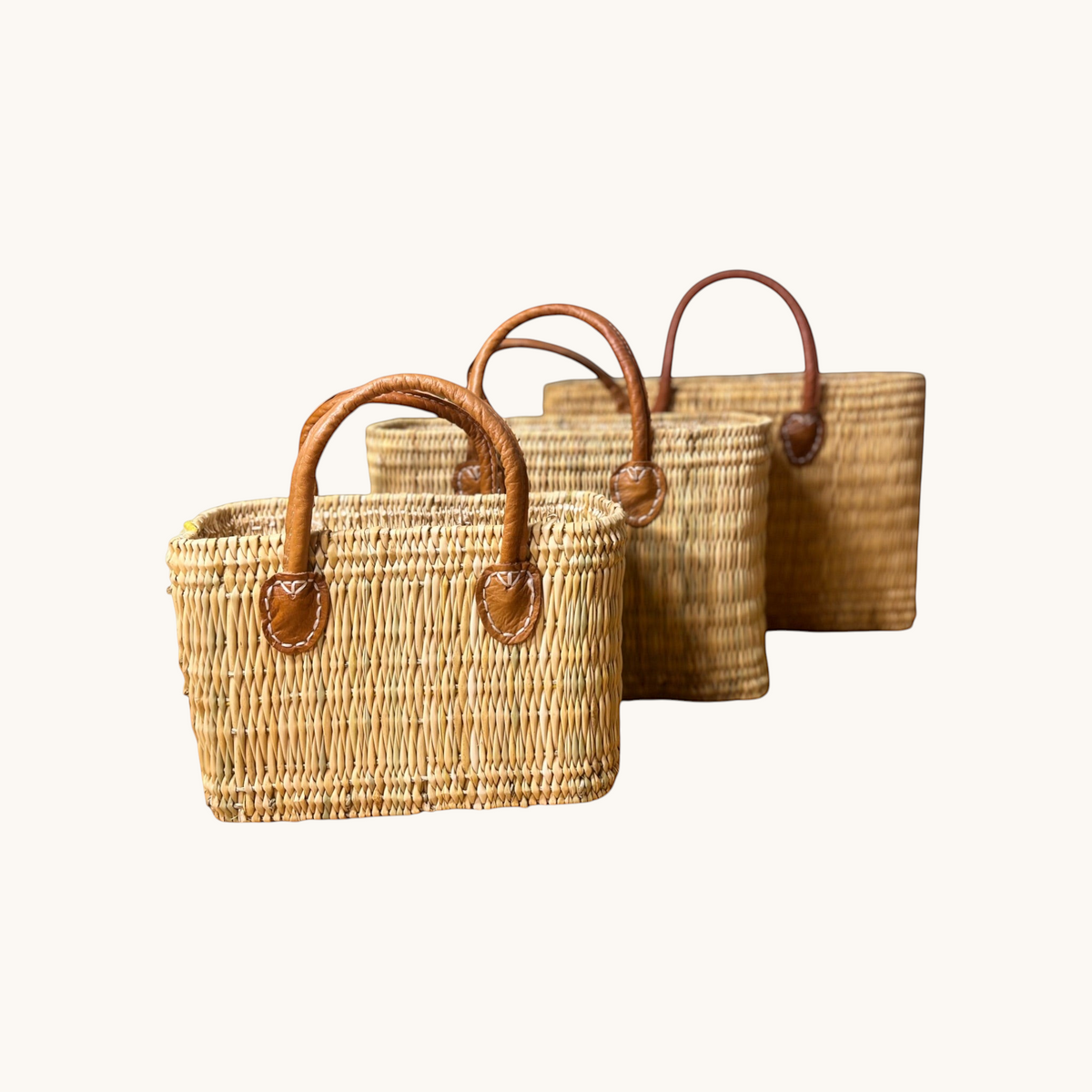 tuyya Yasmine structured Moroccan wicker picnic baskets with camel-colored leather handles in three sizes
