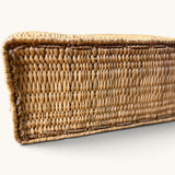 Close-up of the flat rectangular base of a tuyya Yasmine handwoven wicker basket with a rigid structured design.
