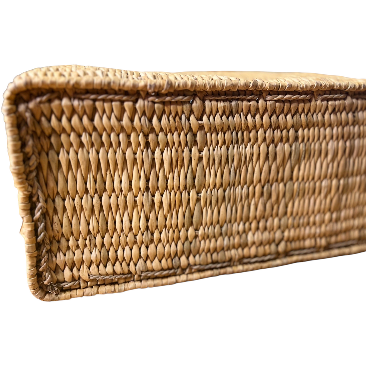 Close-up of the flat rectangular base of a tuyya Yasmine handwoven wicker basket with a rigid structured design.