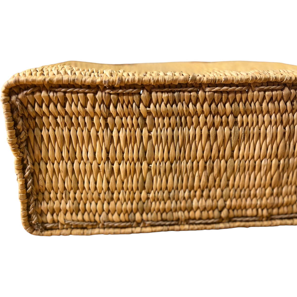 Close-up of the flat rectangular base of a tuyya Yasmine handwoven wicker basket with a rigid structured design.