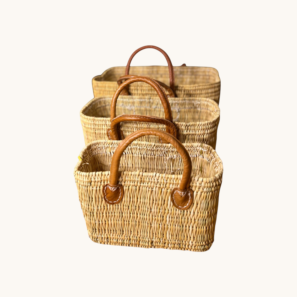 tuyya Yasmine structured Moroccan wicker baskets in three sizes with camel leather handles and rivet details