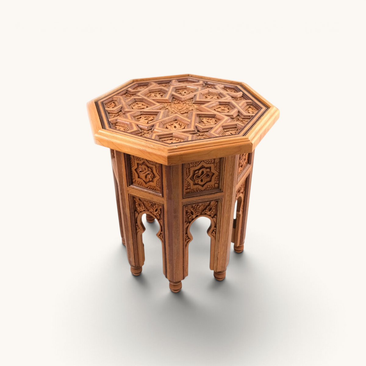 TUYYA octagonal side table featuring hand-carved floral patterns in samba, mahogany, and cedar wood with a glass top.